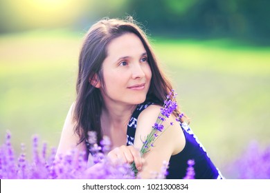 Happy woman on lavender background. Beautiful girl in meadow field. Amazing lavender landscape with gorgeous lady who enjoy aroma and vivid colors. Best photo for 8 march, international women day