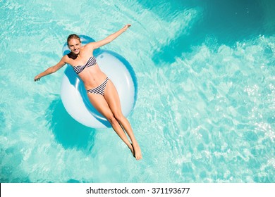 Happy Woman On Lilo In The Pool