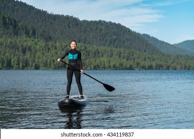 Happy Woman On Paddle Board