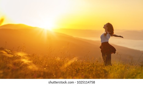 Happy woman   on the sunset in nature in summer with open hands - Shutterstock ID 1025114758