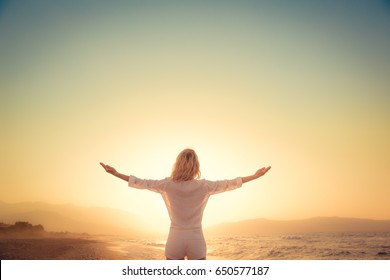 Happy Woman With Open Hands Against Blue Sea And Sky Background. Person Having Fun On Summer Vacation. Freedom And Imagination Concept