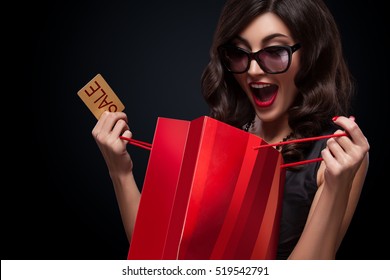 Happy Woman Open Red Bag On Dark Background In Black Friday Holiday