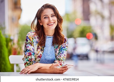 Happy Woman At Outdoors Cafe