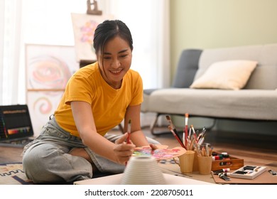 Happy Woman Painting Picture On Canvas With Oil Paints In Bright Living Room. Leisure Activity, Creative Hobby And Art Concept