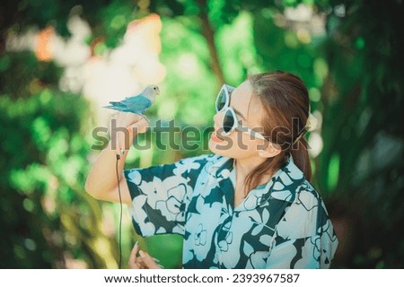 Happy woman and parrot bird enjoying together,pet relationship,Agapornis,Lovebird
Happy woman and parrot bird enjoying together,pet relationship,Agapornis,Lovebird