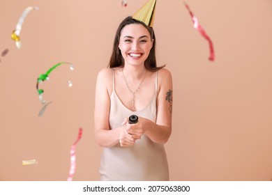 Happy Woman With Party Popper On Color Background