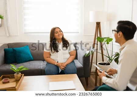 Happy woman patient smiling and feeling grateful to her therapist or psychiatrist after recovering from depression