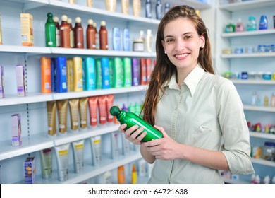 Happy Woman At Pharmacy Buying Shampoo