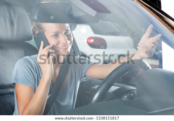 happy woman with phone in\
car