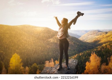 happy woman photographer spreading arms and watching the mountain. Travel Lifestyle success concept adventure active vacations outdoor freedom emotions. - Shutterstock ID 2212216199