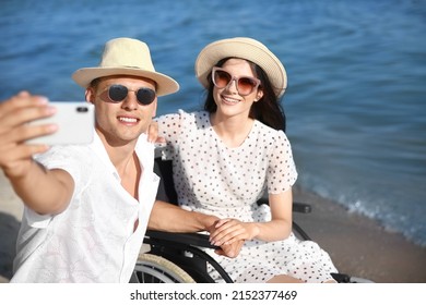 Happy Woman With Physical Disability And Her Boyfriend Taking Selfie At Sea Resort