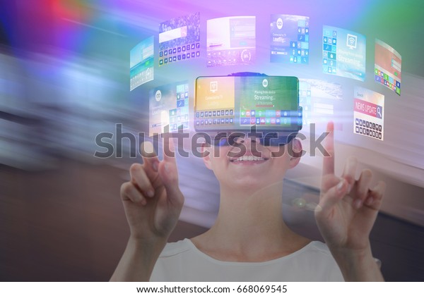 Happy woman pointing upwards\
while using virtual reality headset against view of modern meeting\
room