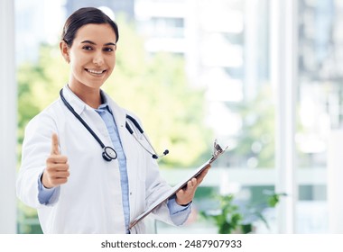 Happy woman, portrait and doctor with thumbs up for winning, success or good job at hospital. Female person or medical employee with smile, like emoji or yes sign for healthcare service or review - Powered by Shutterstock