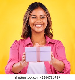 Happy woman, portrait and gift box for present, birthday or event against a yellow studio background. Female person smile giving prize, giveaway or celebration for surprise, package or ribbon parcel - Shutterstock ID 2364786939