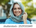 Happy woman, portrait or hijab with fashion in city for islam, tradition or clothing in palestine. Muslim, female person or Arabian refugee with scarf or smile for islamic heritage or culture in town