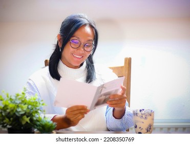 Happy Woman Reading Holiday Greeting Card With Smiling Face. 