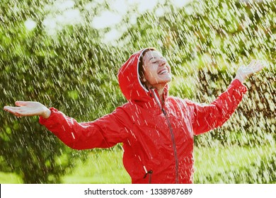 Happy Woman In Red Rain Coat In The Rain