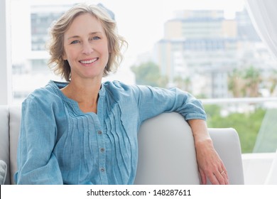 Happy Woman Relaxing On Her Couch At Home In The Sitting Room