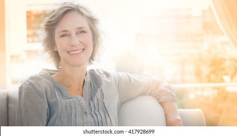 Happy Woman Relaxing On Her Couch At Home In The Sitting Room