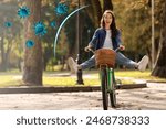 Happy woman riding bicycle outdoors. Strong immunity protecting against viruses