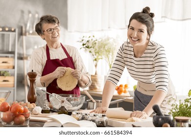 Happy Woman Rolling Dough For Pasta, Cooking Together With Grandma