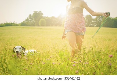 Happy Woman Running With The Dog In Nature