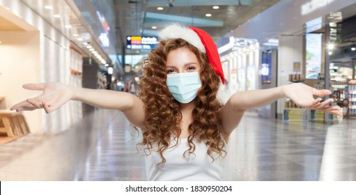 Happy Woman Santa In Protective Medical Mask Having Fun In Mall. Open Shopping And Christmas Sale Concept