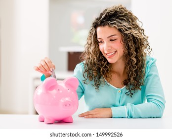 Happy Woman Saving Money In A Piggybank 