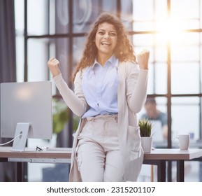 Happy woman screams make a winner gesture with clenched fists - Shutterstock ID 2315201107
