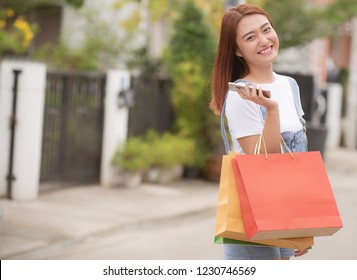  Happy woman with shopping bags enjoying in shopping  

Online Shopping Concept - Shutterstock ID 1230746569
