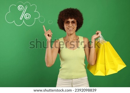 Happy woman with shopping bags implying discount offer on green background. Thought bubble with percent sign near her