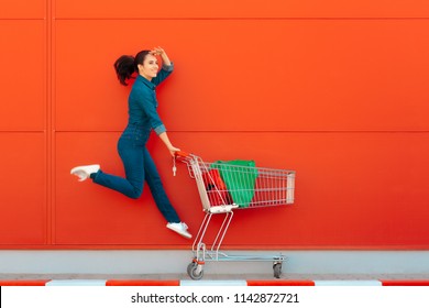 Happy Woman With Shopping Jumping With Joy. Excited Supermarket Customer On Sale Season
