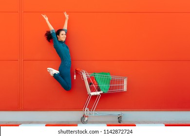 Happy Woman With Shopping Jumping With Joy. Excited Supermarket Customer On Sale Season
