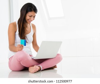 Happy Woman Shopping Online With A Credit Card