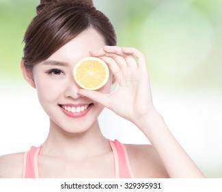 Happy Woman show orange benefit to health, asian beauty
