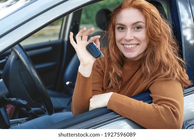 Happy Woman Showing Car Key After New Car Purchase