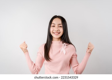 happy woman showing pink ribbon, Breast cancer awareness, world cancer day, national cancer survivor day in february concept.	 - Shutterstock ID 2231543329