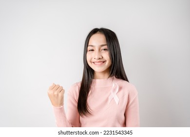 happy woman showing pink ribbon, Breast cancer awareness, world cancer day, national cancer survivor day in february concept.	 - Shutterstock ID 2231543345