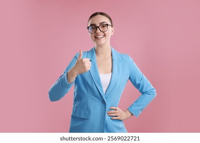 Happy woman showing thumbs up on pink background. Like gesture - Powered by Shutterstock - Get 15% off with code: PIKWIZARD15