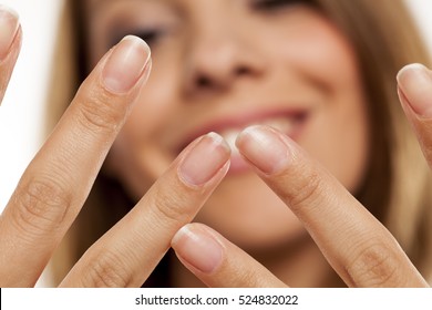 Happy Woman Shows Her Natural Nails Without Nail Polish