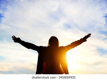 Happy Woman Silhouette with Hands Up on the Sky Background