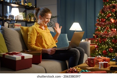 Happy Woman Sitting On The Couch And Video Calling Her Friends On Christmas Day