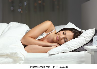 Happy Woman Sleeping On The Bed In The Night At Home