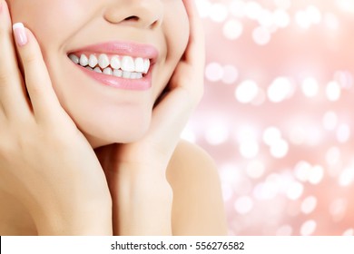 Happy woman smiling on an abstract background with blurred lights - Shutterstock ID 556276582