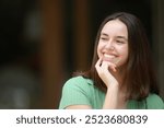 Happy woman smiling with perfect teeth in the street looks at side