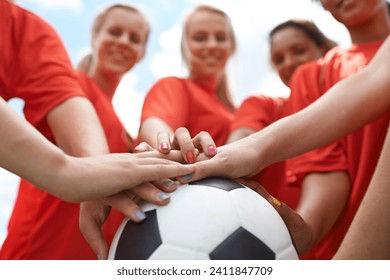 Happy woman, soccer ball and hands together for teamwork, unity or motivation on outdoor field. Closeup of group, people or football players piling in support for sports club, match or game outside - Powered by Shutterstock