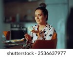 

Happy Woman Spreading Cream Cheese on Bread for Breakfast. Cheerful person having fun preparing breakfast with diary product 
