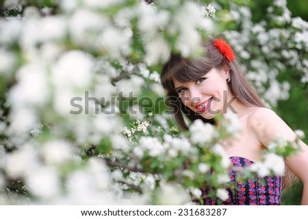 happy woman in the spring, in the lush garden.