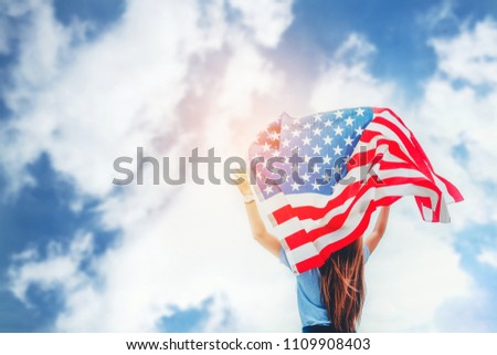 Happy woman standing with American flag Patriotic holiday.USA celebrate 4th of July