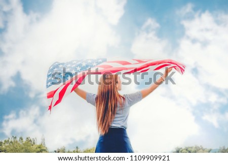 Happy woman standing with American flag Patriotic holiday.USA celebrate 4th of July